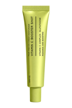 A single tube of Vitamin C Booster Shot face and skin moisturizer in a metallic chartreuse green packaging, shown against a solid white background.